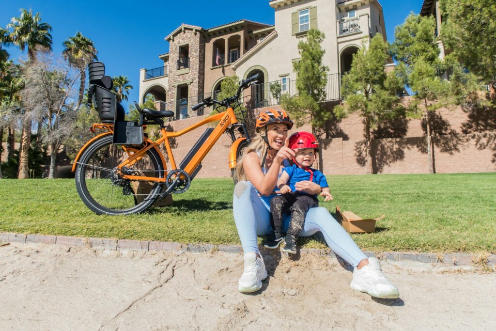 girl in red helmet riding on bicycle