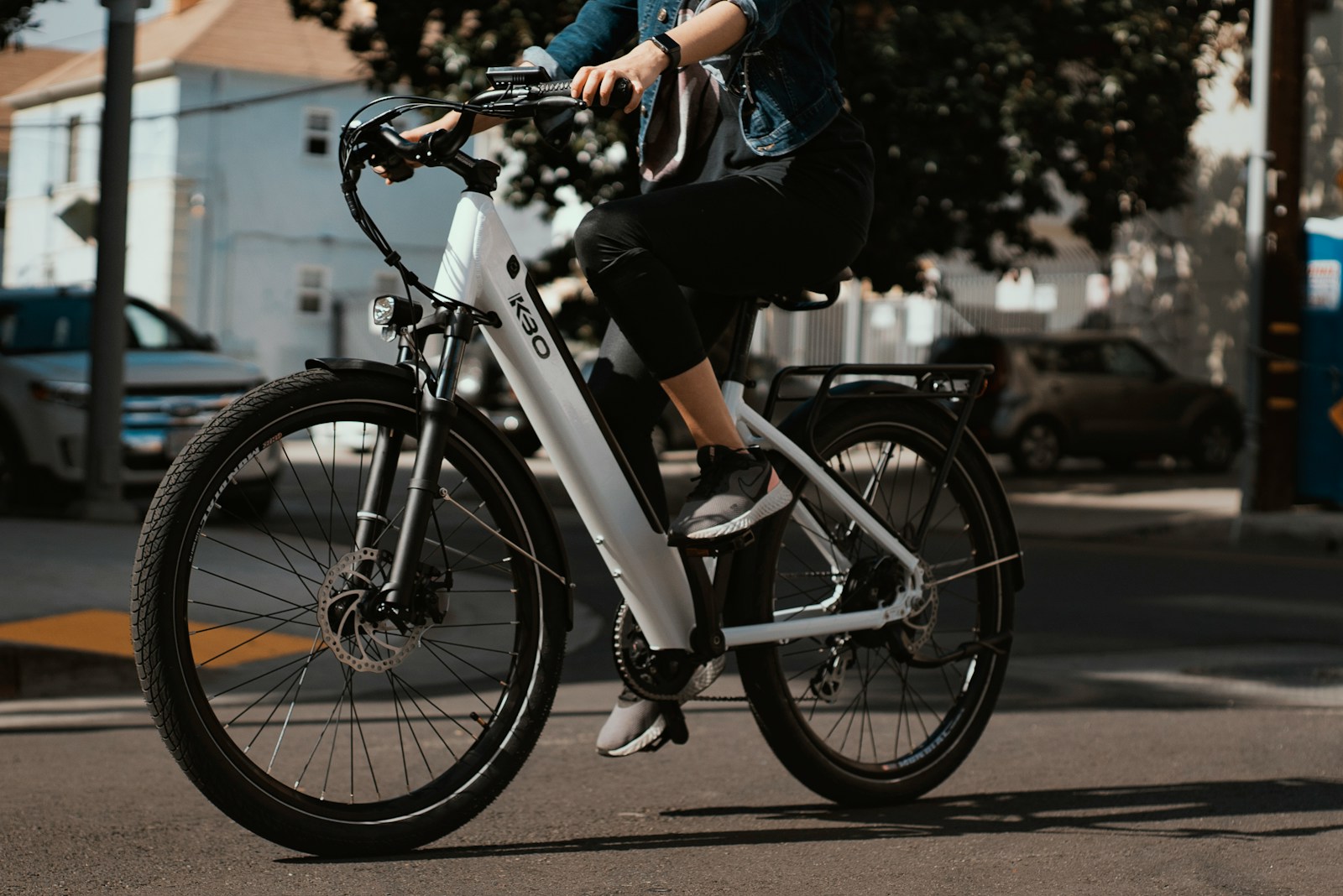 man in black jacket riding on white and black bicycle