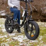 a person sitting on a bike in the snow