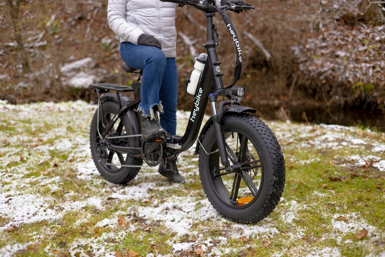 a person sitting on a bike in the snow